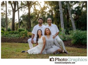 family sitting on the grass for family photos on Kiawah Island