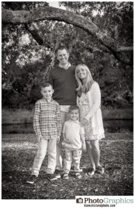 Family of four posing in grass, photo in black and white, kiawah island, kiawah island family photographer